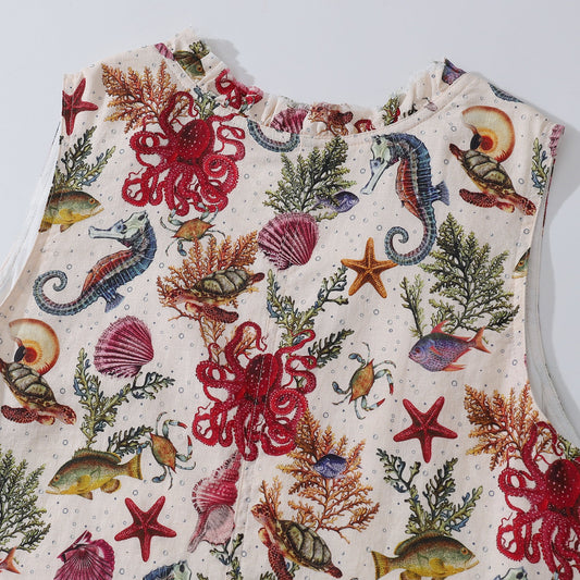 Close-up of marine life design on Hawaiian dress, V-neck