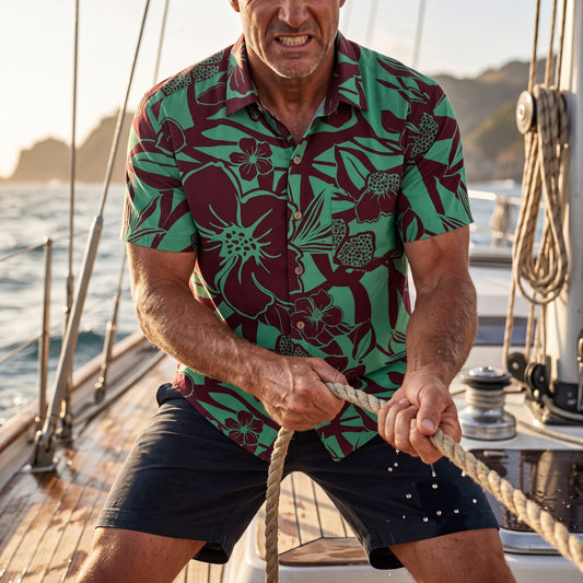 Model wearing green tropical print Hawaiian shirt
