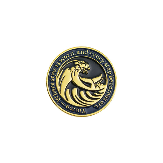 Gold-tone zinc alloy badge with artistic wave design