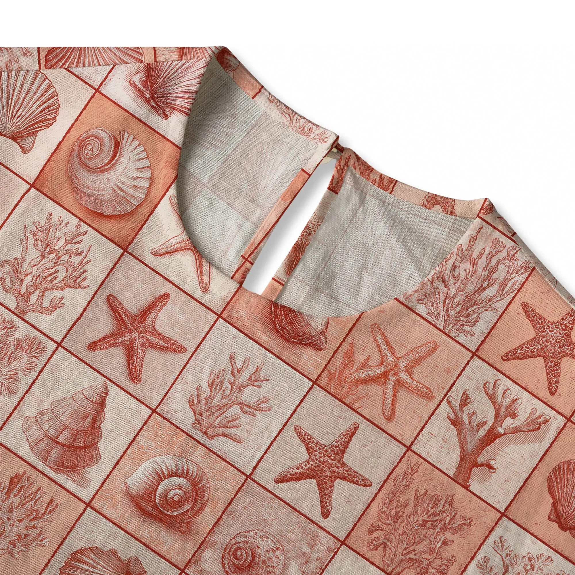 Back view of coral red button-back blouse with ocean elements