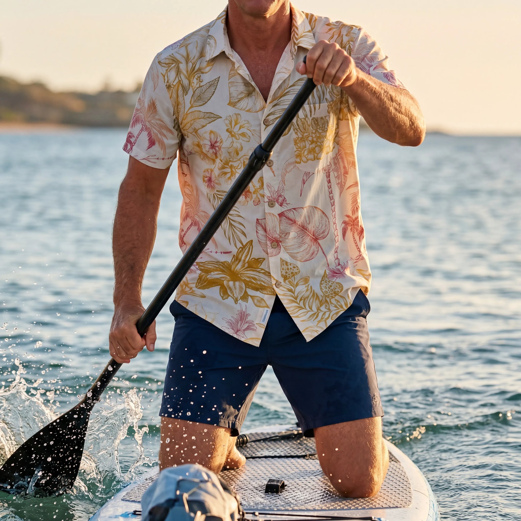 Model wearing LeosWare men's Hawaiian shirt with tropical design