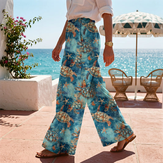 Women's blue wide leg pants with golden turtle design, resort wear